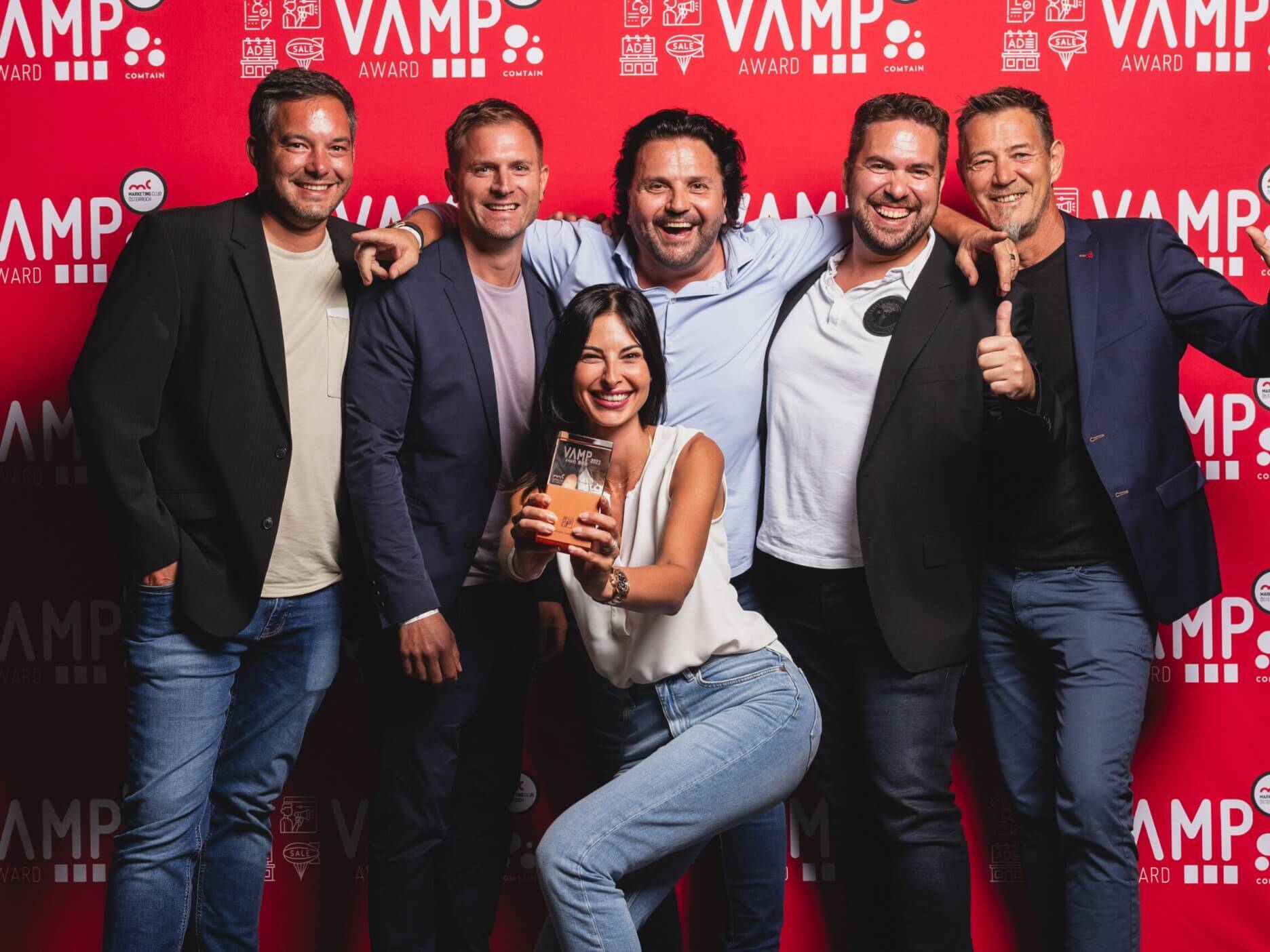VAMP Award Gruppenbild mit fünf Männern und einer Frau vor einer roten Fotowand